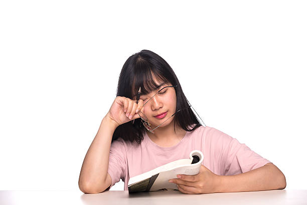 istock girl student sitting behind desk tired 613891218