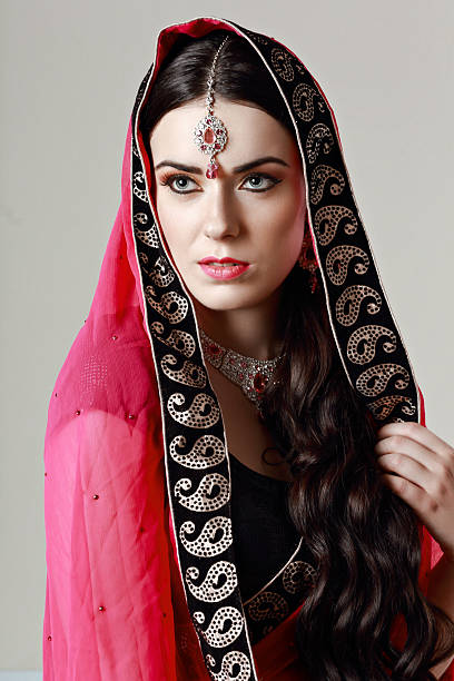 istock beautiful Indian woman looking afar 613893310