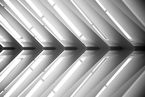 Roof structure. Lath ceiling. Joist, rafter. Abstract black and white photo of contemporary architecture or interior fragment / detail. Geometric pattern with regular angular structure.
