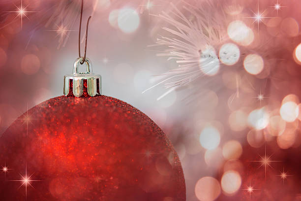 istock Closeup of red bauble hanging from a decorated Christmas tree. 613894278