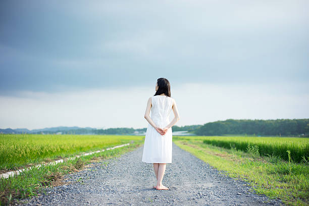 istock Woman standing in a rice paddy 613895118