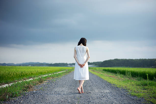 istock Woman standing in a rice paddy 613895340