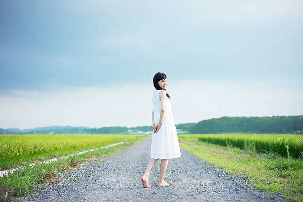 istock Woman standing in a rice paddy 613895418