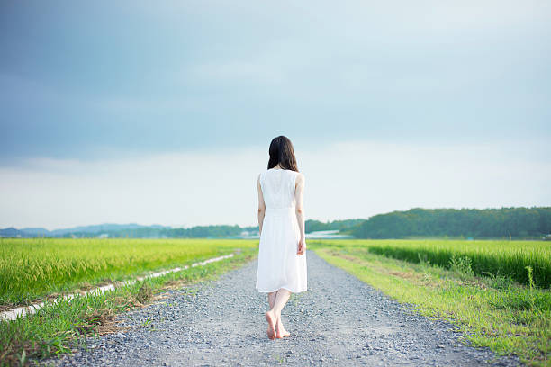 istock Woman standing in a rice paddy 613895500