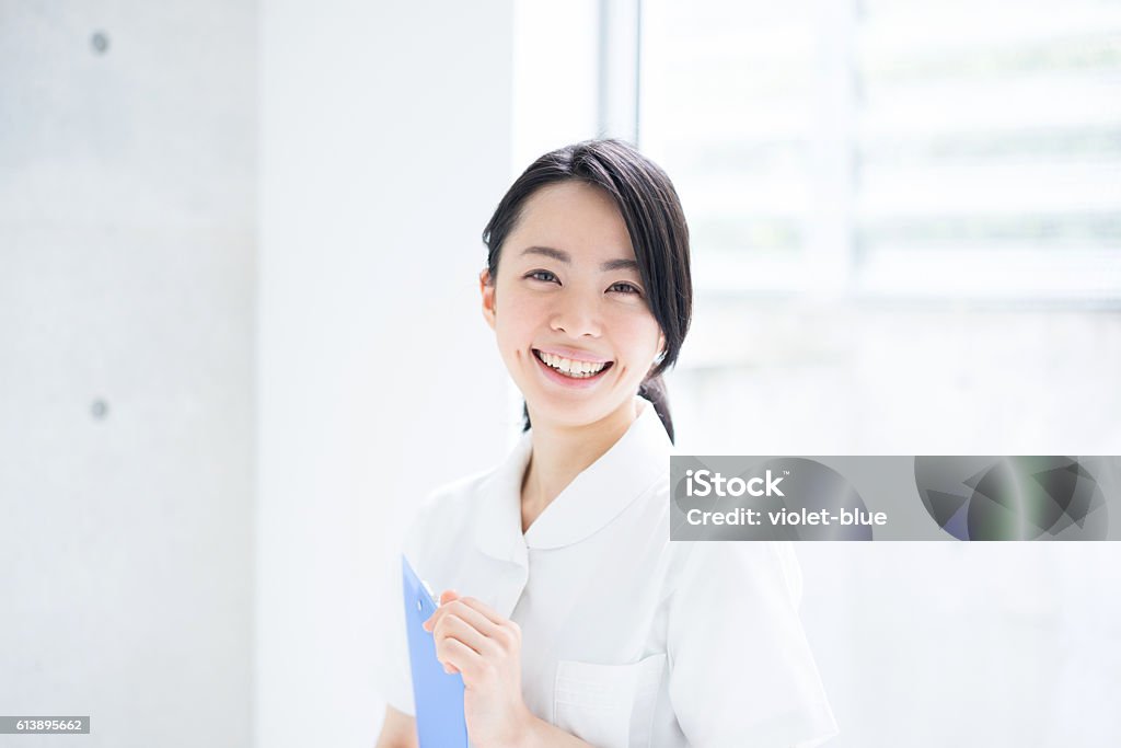 Female nurse holding a clipboard Nurse Stock Photo