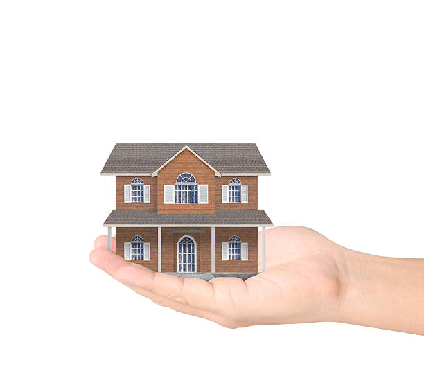 istock Mortgage concept by house from hand 613895986