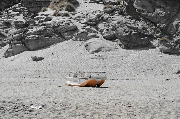 Tinos Island, Greece - August 22, 2016: Small boat left alone at a beach called Kolibithres in Tinos Island