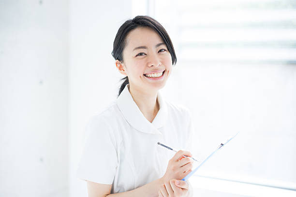 Female nurse writing on clipboard stock photo