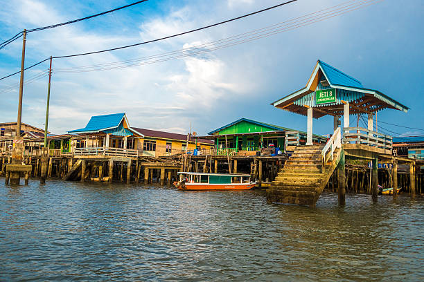 Bandar Seri Begawan, Brunei - September 15, 2016: Kampong Ayer or floating village water taxi stop - on close inspection a woman can be sen waiting. The village houses around 39000 people and is said to have been inhabited for over 1300 years.