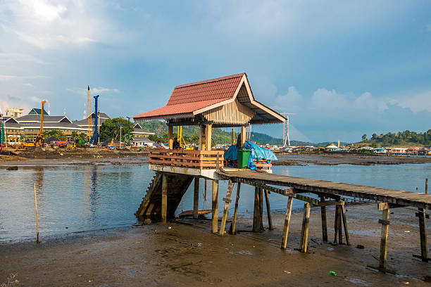 Bandar Seri Begawan, Brunei - September 15, 2016: People wait for water taxis at a Kampong Ayer or floating village water taxi stop. The village houses around 39000 people and is said to have been inhabited for over 1300 years.