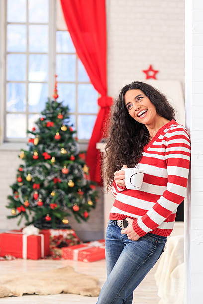 istock Beautiful young woman drinking coffee at home 613902188