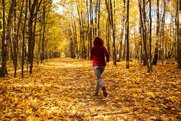 istock Woman in autumn park 613904574