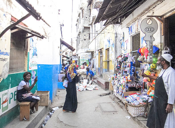 Narrow street of Lamu town Lamu, Kenya - September 3, 2013: Narrow street and african people in Lamu town. Kenya. Eastern Africa xxi stock pictures, royalty-free photos & images