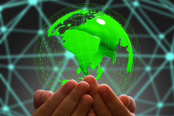 istock kid's hand holding  globe in  dark background 613906828