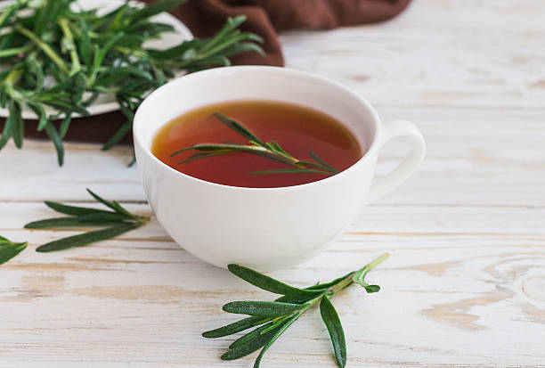 istock Rosemary tea and milk jar on wooden table. 613906910