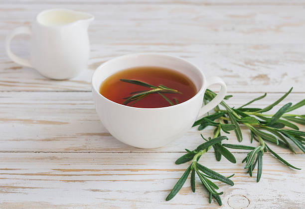 istock Rosemary tea and milk jar on wooden table. 613906972