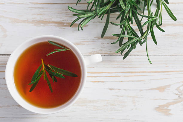 istock Rosemary tea and milk jar on wooden table. 613907054