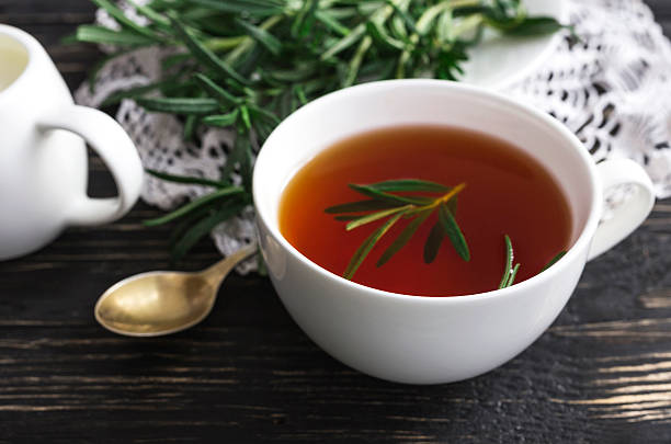 istock Rosemary tea and milk jar on wooden table. 613907318