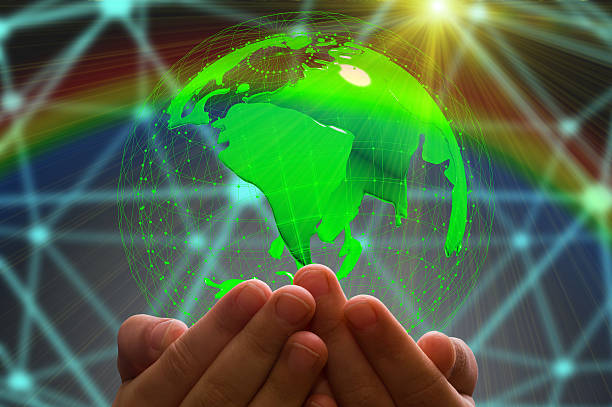 istock kid's hand holding globe in dark background 613908248