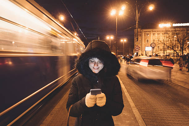 istock Woman texting at the bus stop 613908254