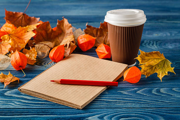 istock Autumn leaves, hot steaming cup of coffee 614011128