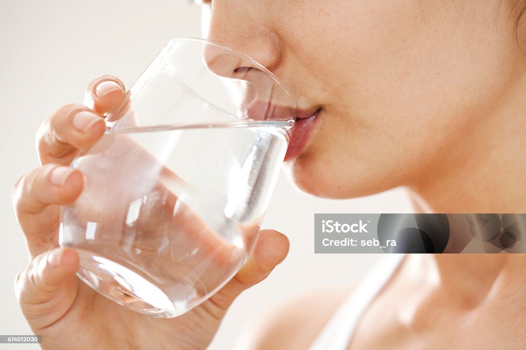 Young woman drinking  glass of water Water Stock Photo