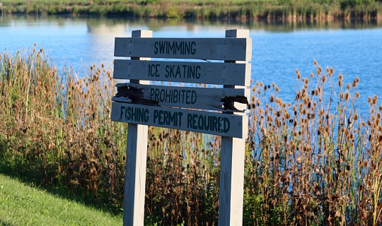 A sign with the lake in background.
