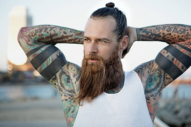 Heavily Tattooed Bearded Athletic Alternative Man Stretching Before A  Workout Stock Photo - Download Image Now - iStock