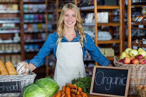 istock Smiling staff standing in organic section 614014498