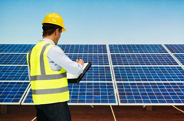 istock Rear view of solar worker working outdoors 614016324