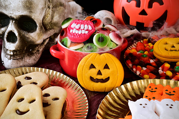 istock cookies and candies on an ornamented table for Halloween 614016788