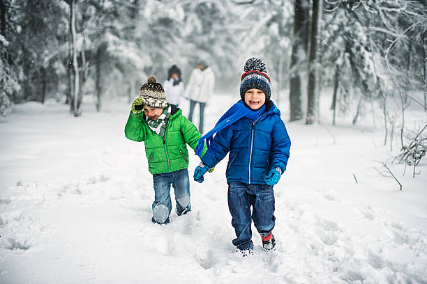 little brothers with family enjoying winter walk in forest. - family winter walking fun imagens e fotografias de stock