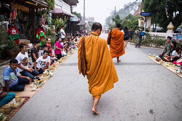Loei, Thailand, - November, 30, 2014 : Unidentified People give food and sticky rice to monks for merit time on early morning at Chiang Khan Loei, Thailand.
