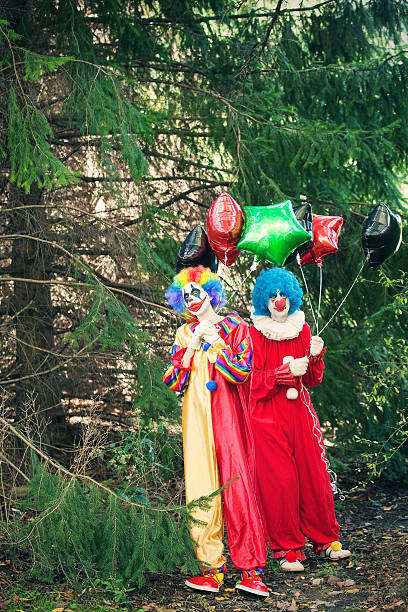 istock Creepy Clowns With Balloons In Woods 614018856