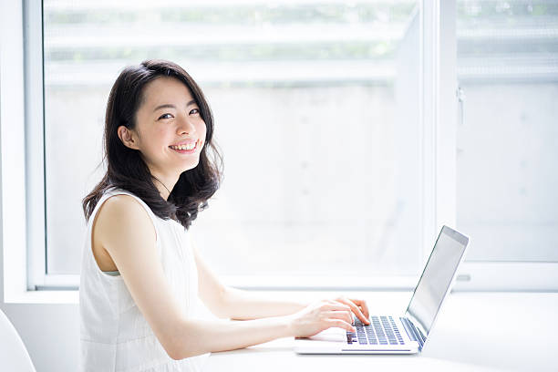 Woman using a laptop stock photo