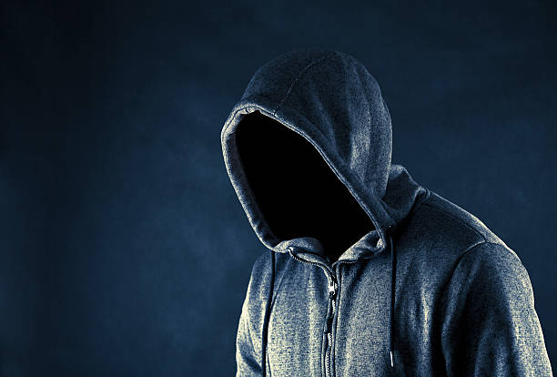 istock Hooded man in the dark 614020006