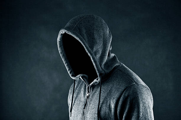istock Hooded man in the dark 614021980