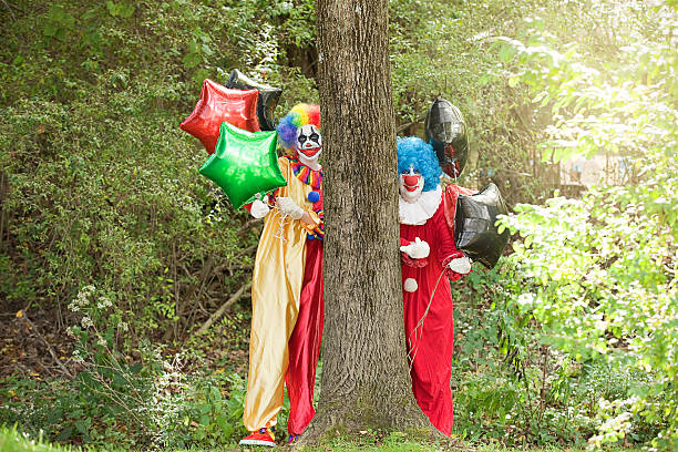 istock Creepy Clowns Luring People Into Woods With Balloons 614022980