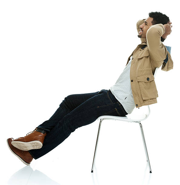 istock Smiling casual man sitting on chair 614023378