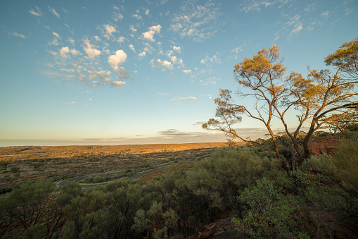 Beautiful sun setting down on the Australian outback. Kings Canyon in the far horizon.