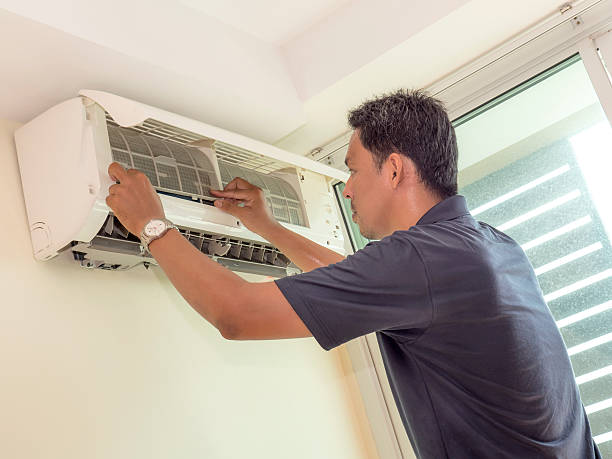 istock Single electrician man clean, fix and maintain air conditioning 614023692