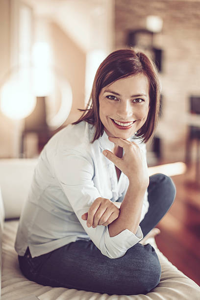 istock Beautiful young woman at home 614026126