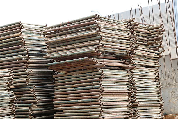 Pile of rusty pipe staging. Stack of spare extensive scaffoldingin lying in a construction area. Used construction material storage at the start or end of the project.