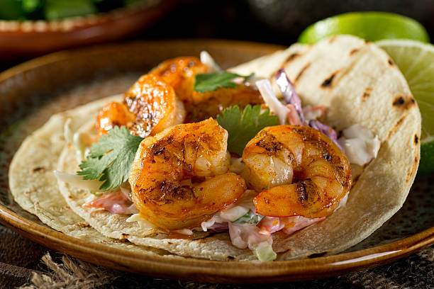 Shrimp Tacos Delicious spicy shrimp taco with creamy cilantro slaw and lime. coleslaw stock pictures, royalty-free photos & images