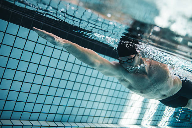istock Pro swimmer practising in swimming pool 614027402