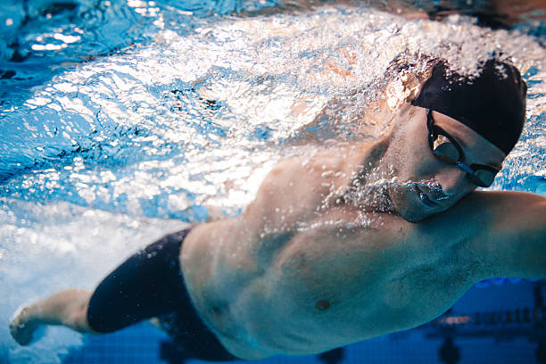 istock Professional male swimmer inside swimming pool. 614027436