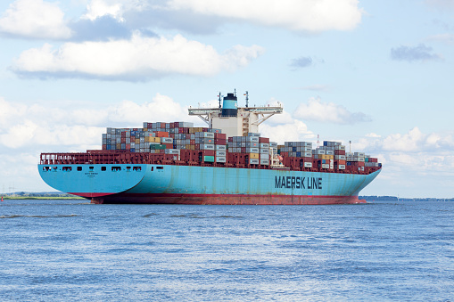 Stade, Germany - August 21, 2016: EDITH MAERSK, one of the world's largest cargo ships, operated by Danish shipping company Maersk Line, near Hamburg on Elbe river.