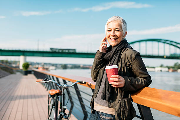 istock Mature Woman Talking On The Phone And Drinking Coffee. 614028954