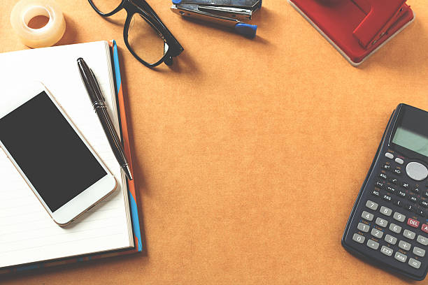 istock Topview of wooden desktop with office tools. Mock up 614030872