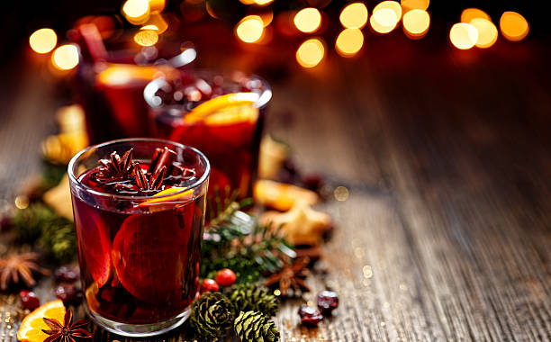 Christmas mulled red wine in a glass Christmas mulled red wine in a glass on a wooden table punch drink stock pictures, royalty-free photos & images